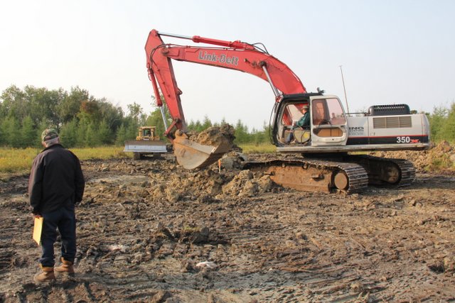 Digging a deeper area Walker Wetlands pond